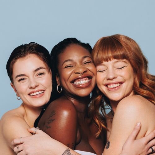 3 women smiling at the camera after receiving botox injections at Medi Aesthetics, Clapham Common.